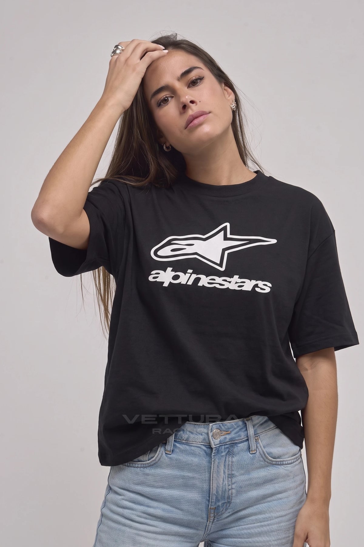 Woman wearing the Alpinestars racing t-shirt in black, front view with the star mark
