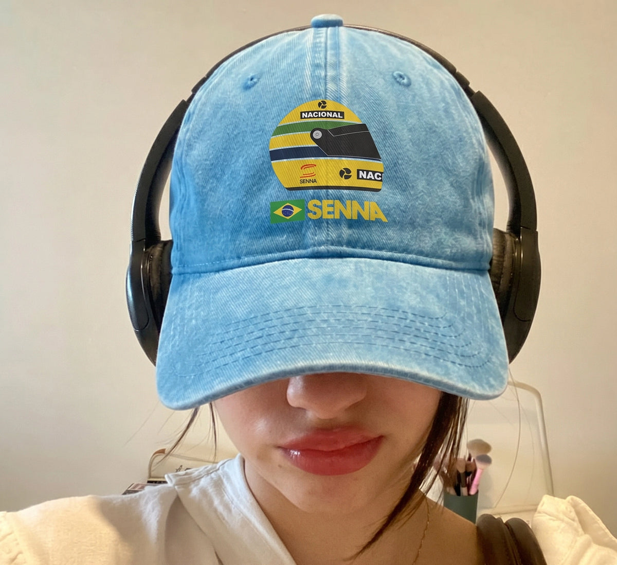 Model wearing the sky blue Senna F1 cap with headphones