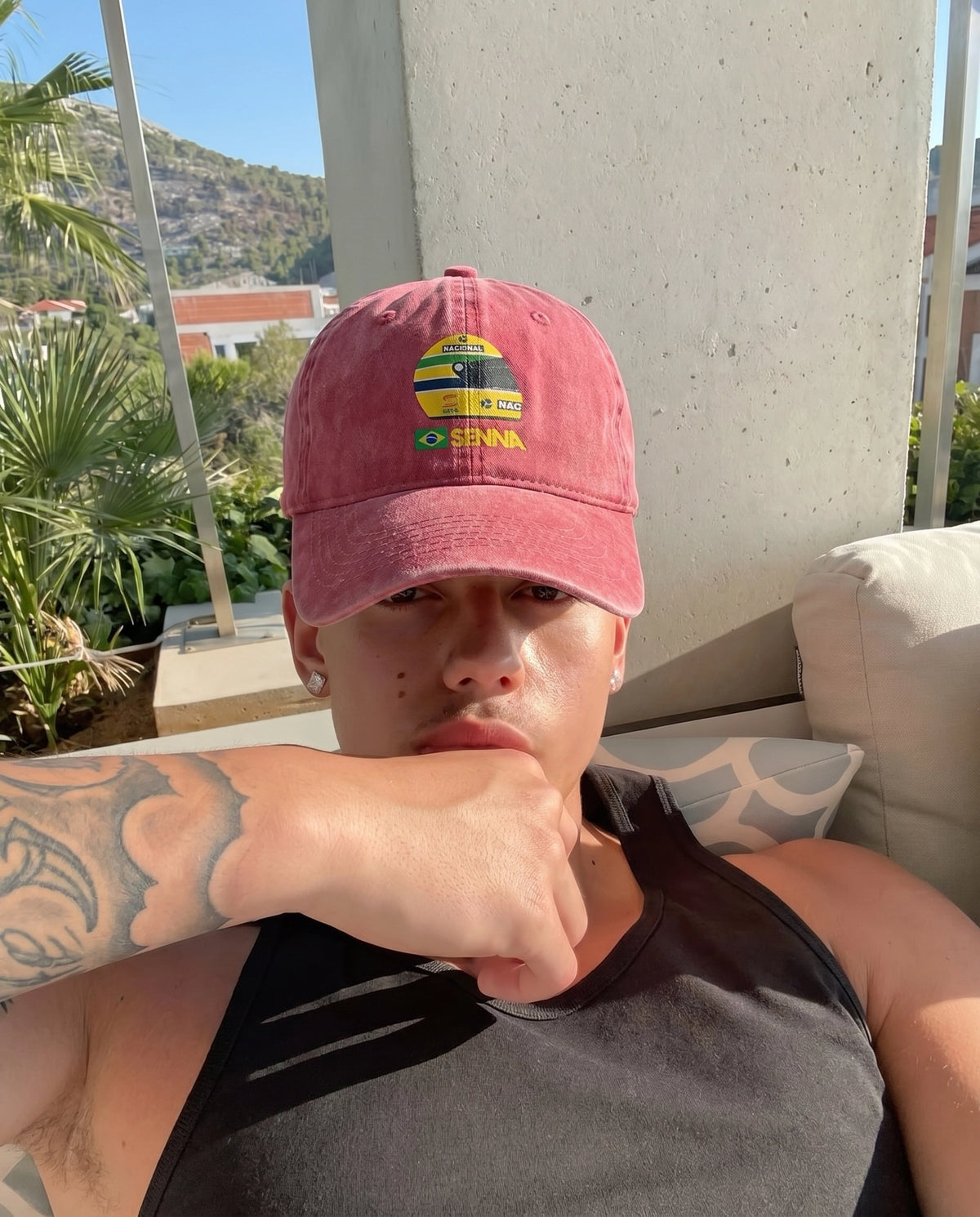 Red Senna F1 cap worn outdoors