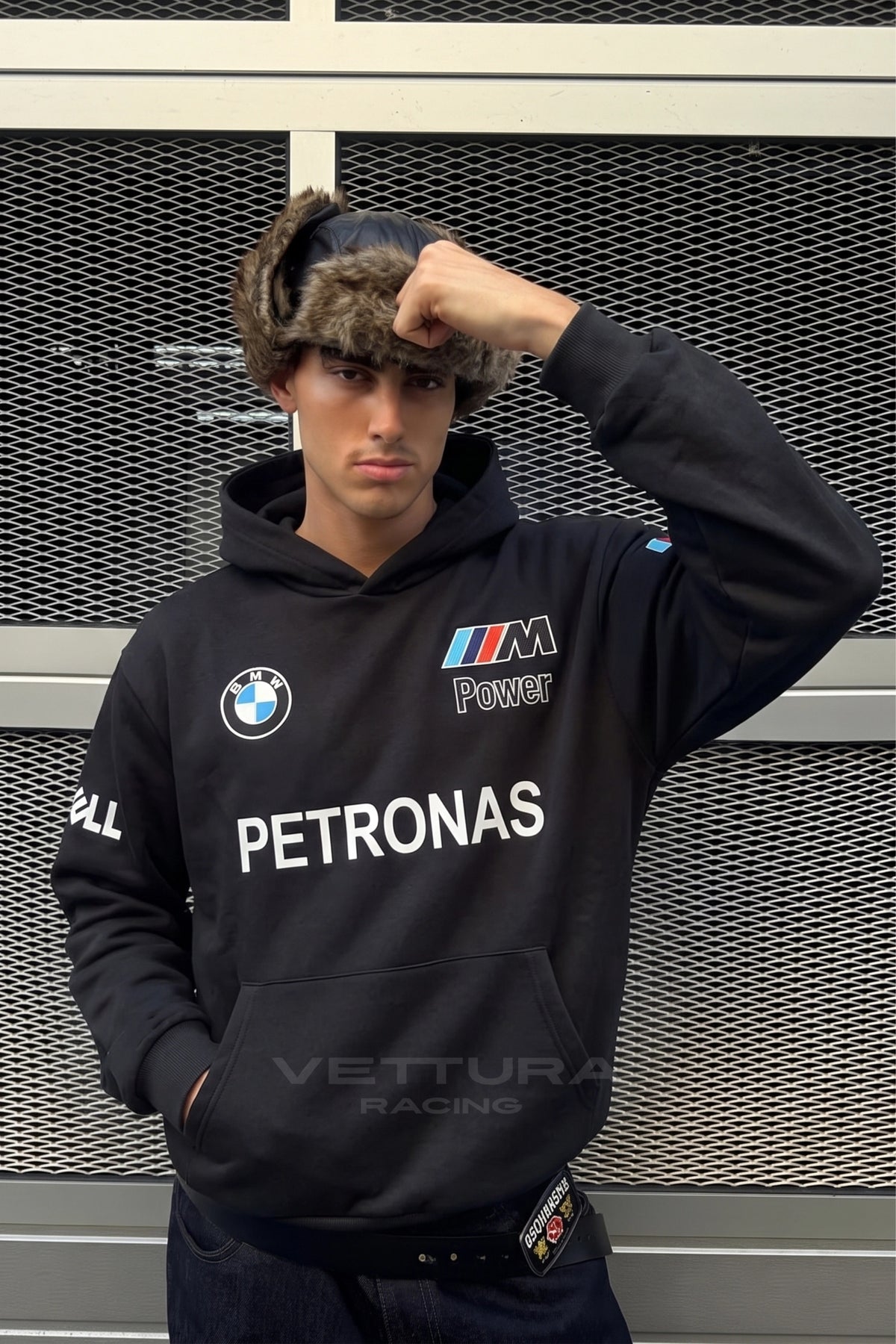 Close view of the embroidered BMW roundel on the black hoodie
