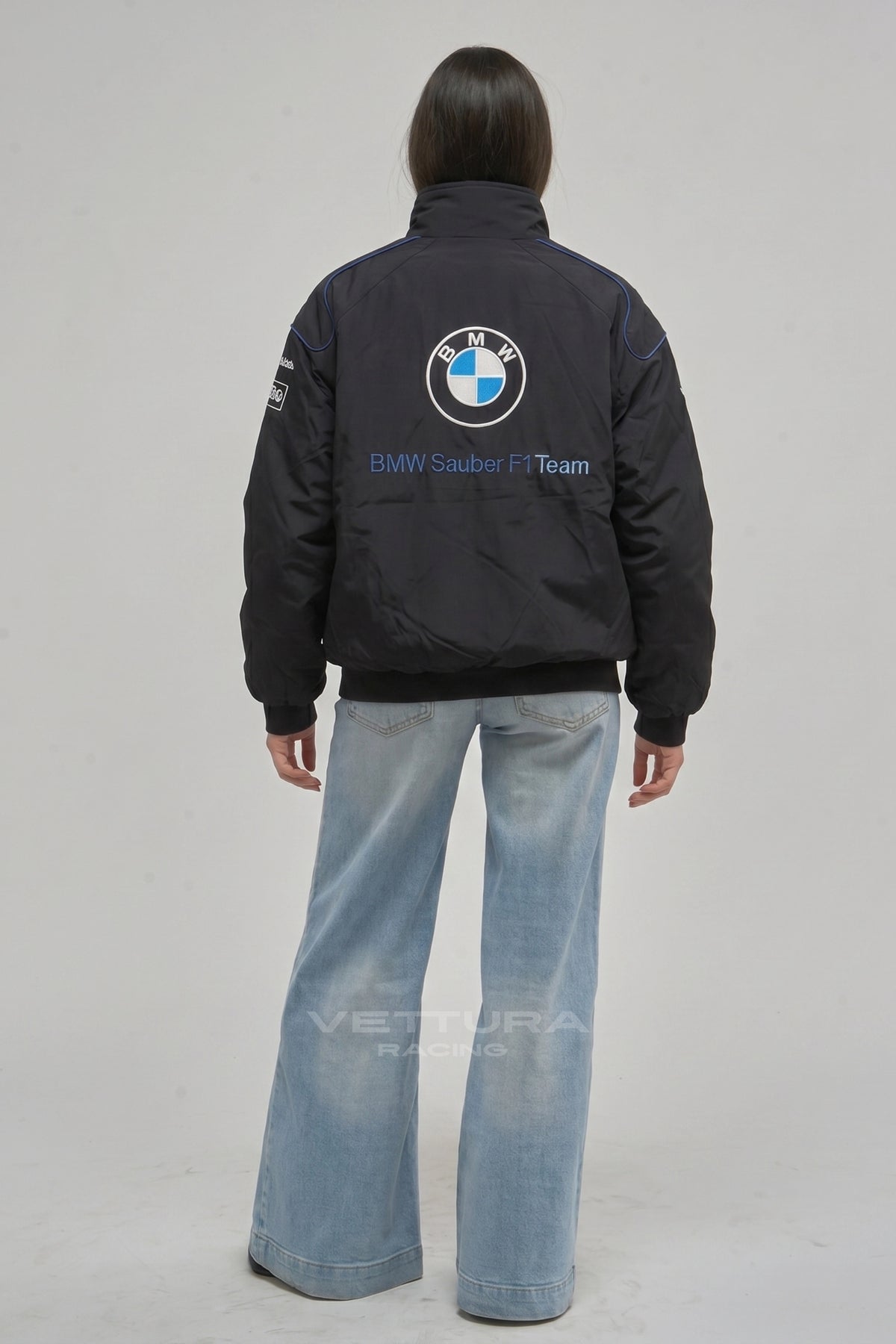 BMW F1 racing jacket on a model, showing the M stripe shoulders
