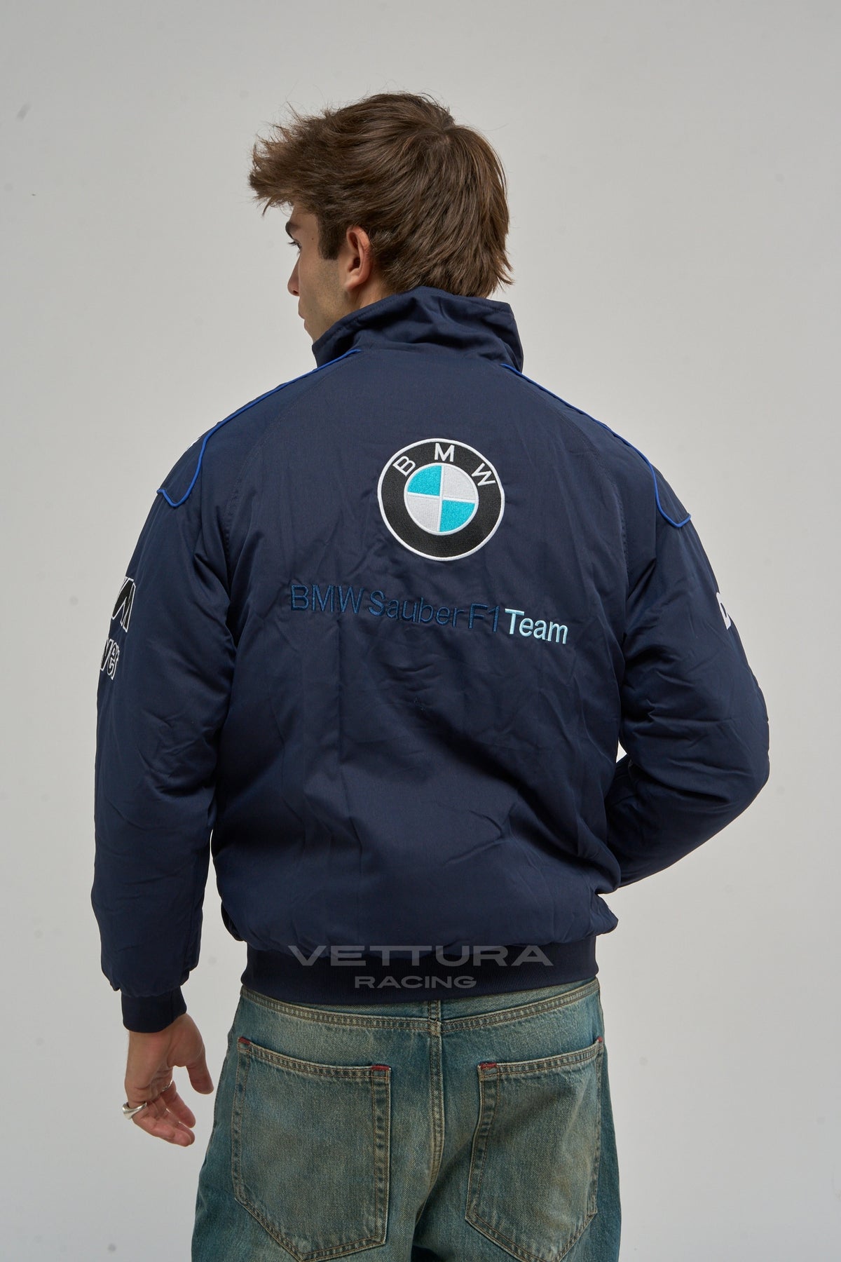 Back of the navy BMW Petronas vintage racing jacket on a model