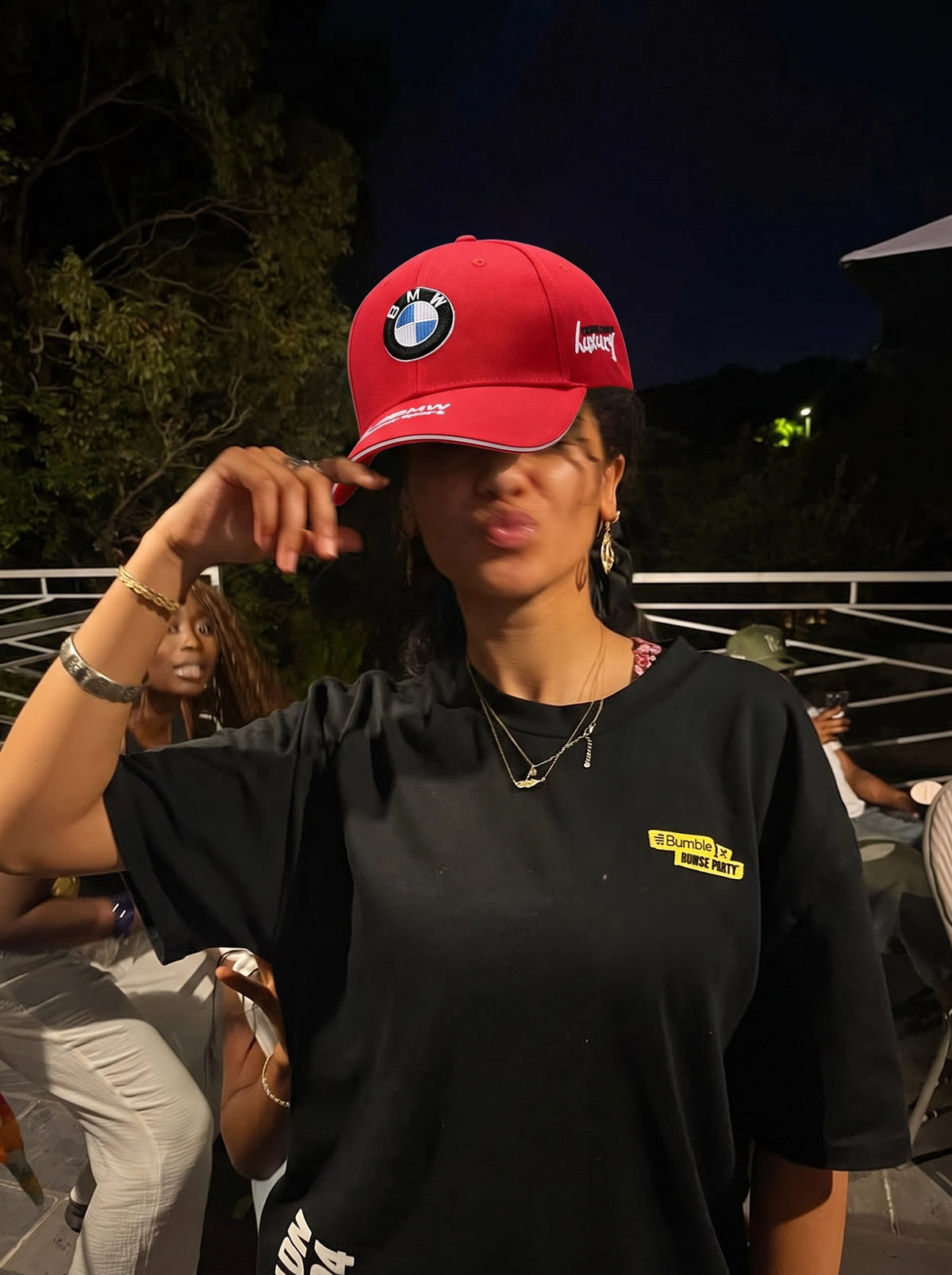 Red BMW Motorsport cap worn outdoors