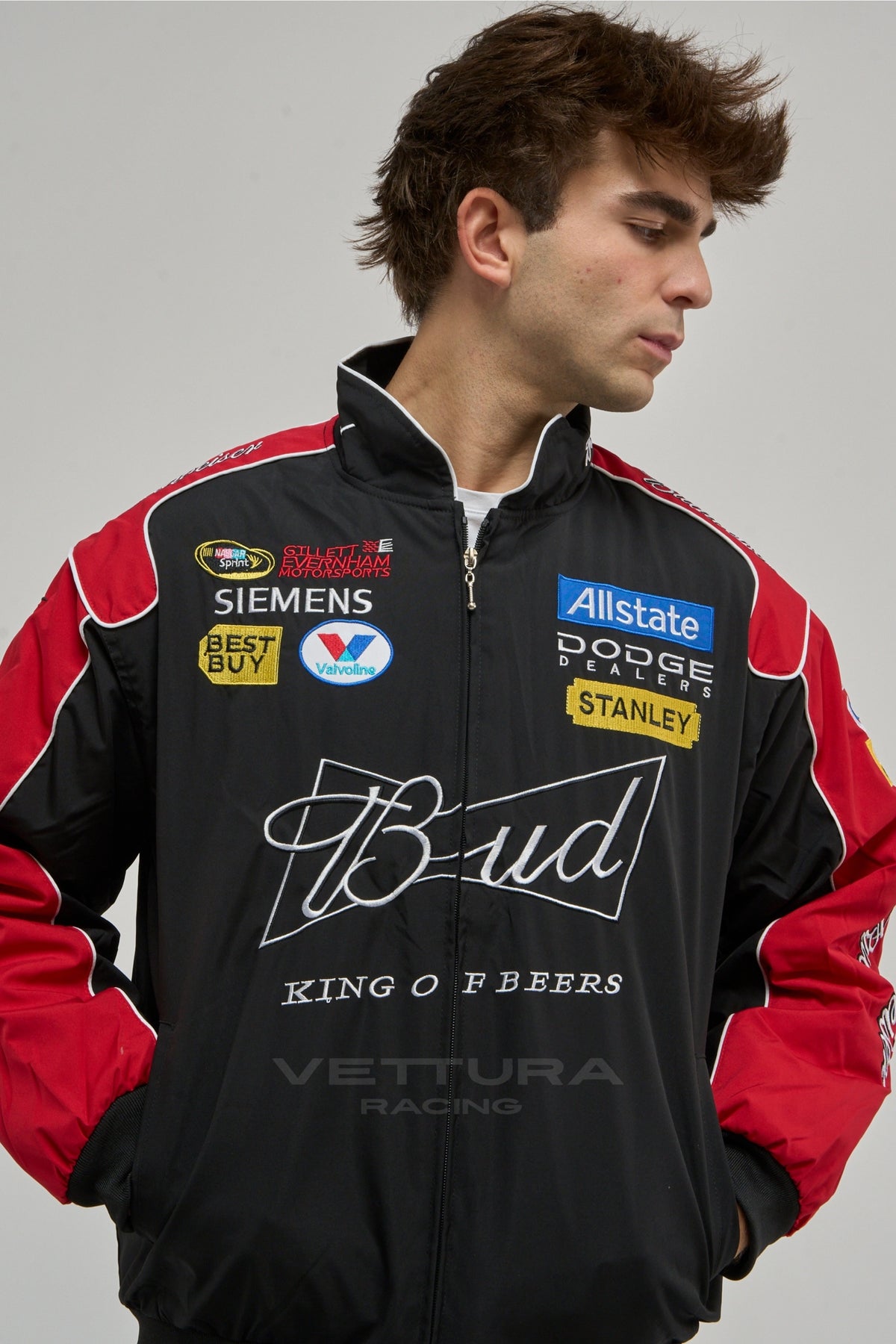 Model wearing the black and red Budweiser NASCAR vintage racing jacket, front view