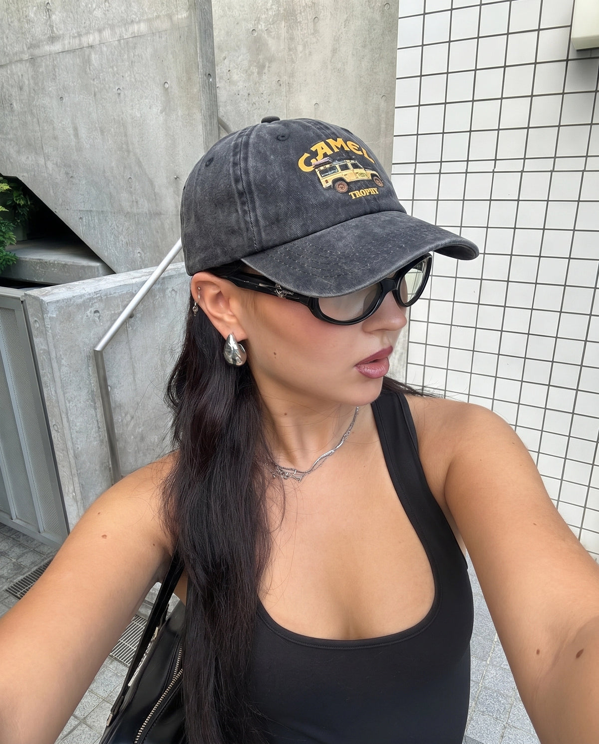 Camel 4x4 cap worn with sunglasses in the street
