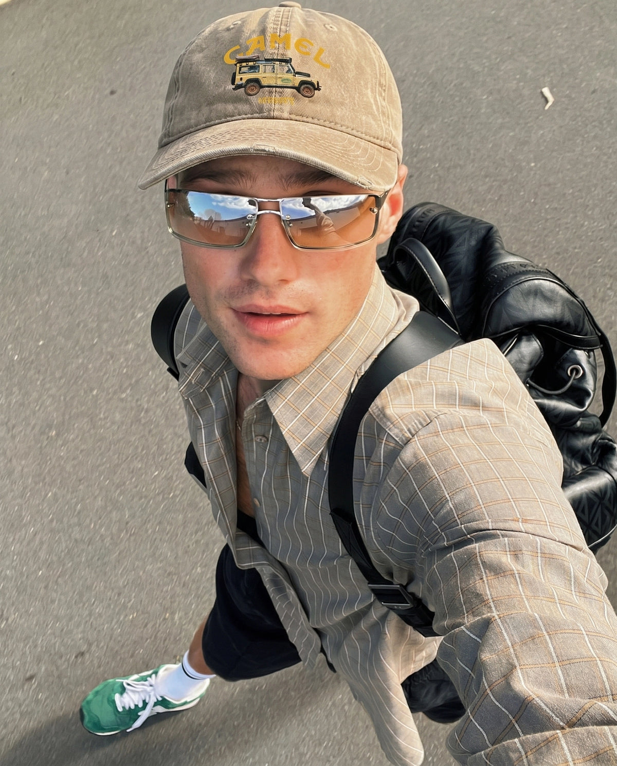 Beige Camel 4x4 cap worn outdoors with a backpack