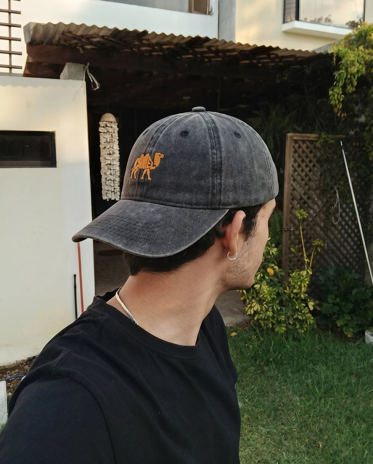 Camel embroidered cap worn with a black tee