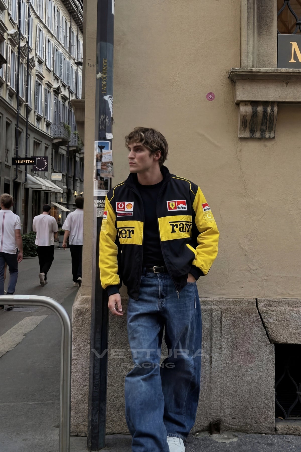Close view of the embroidered Ferrari script on the yellow chest block