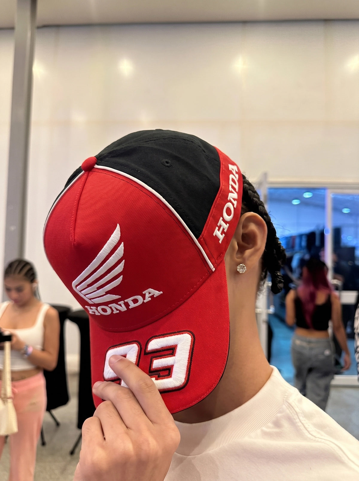 Model wearing the red Honda 93 racing cap