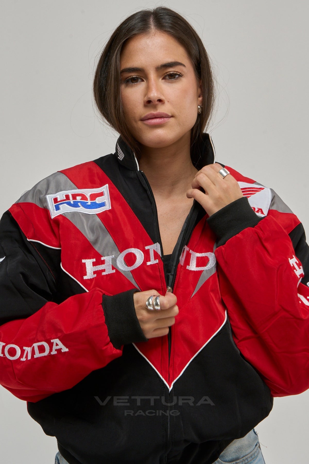 Close view of the Honda chest wordmark on the racing jacket