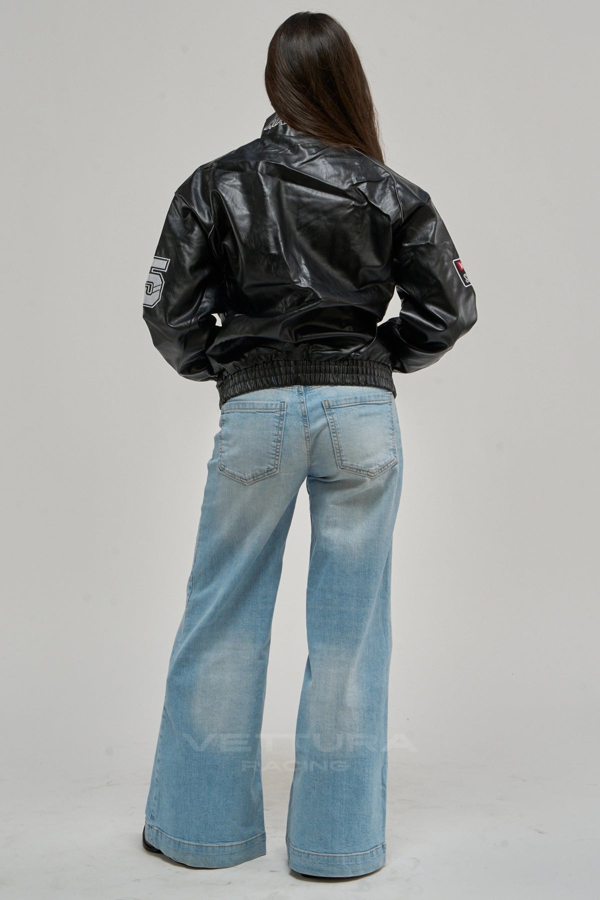 LAP 85 black racing jacket on a model, sleeve patch detail
