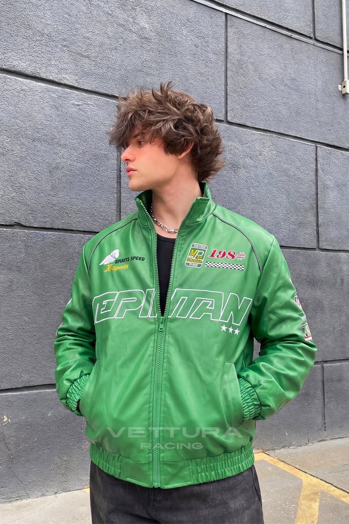 Close view of the chest wordmark on the LAP 85 green jacket