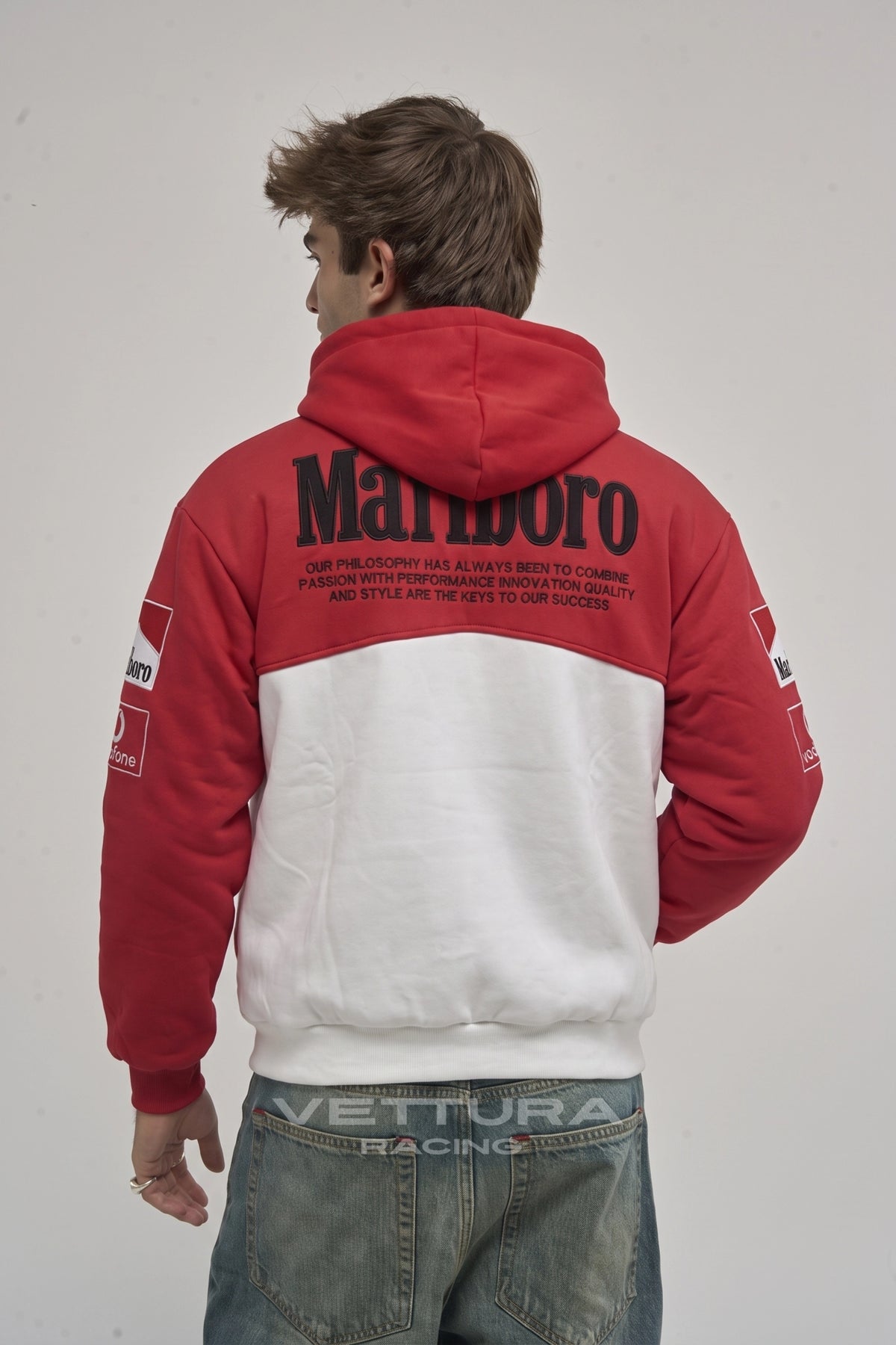 Close view of the embroidered Shell and Vodafone patches on the Marlboro Ferrari hoodie