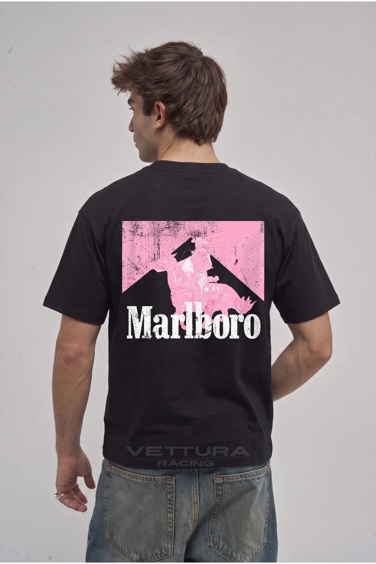 Man wearing the Marlboro pink edition tee, back view with the oversized pink Marlboro block