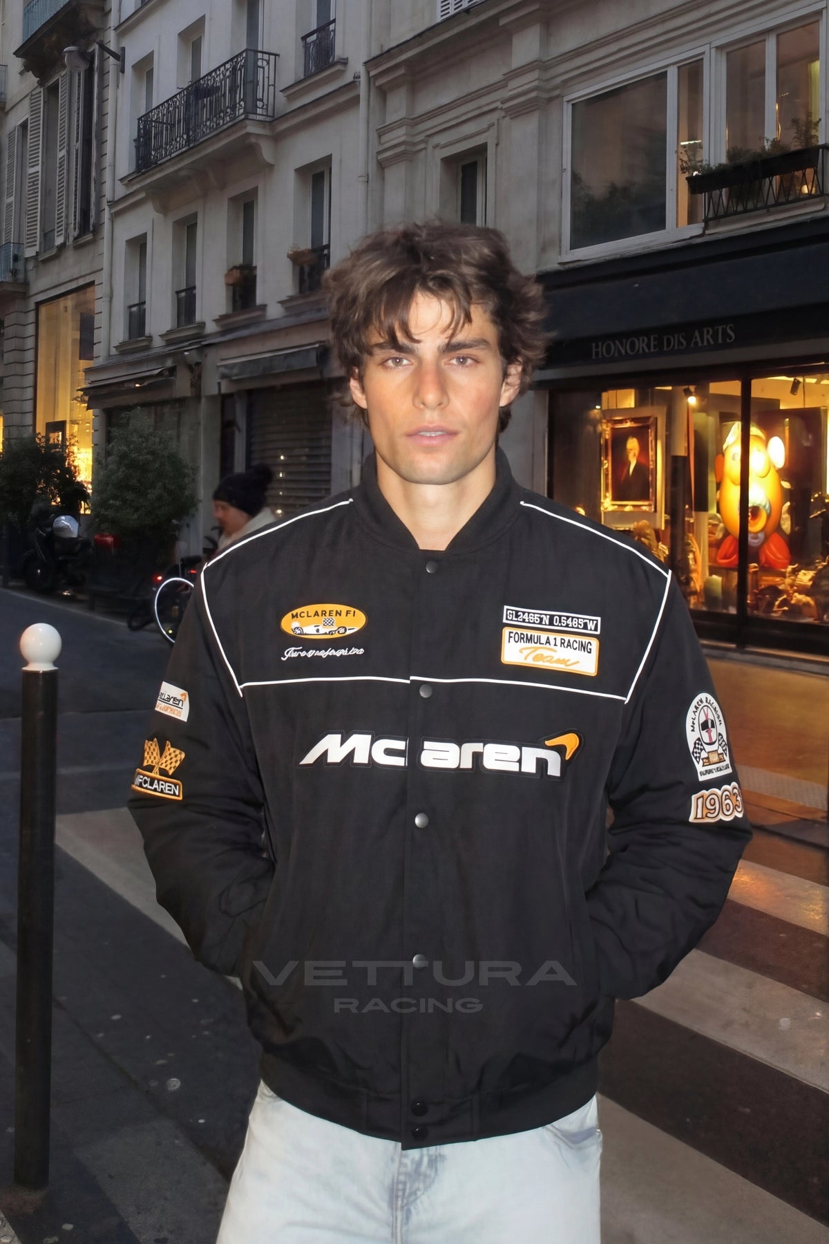 Close view of the McLaren chest wordmark on the black racing jacket