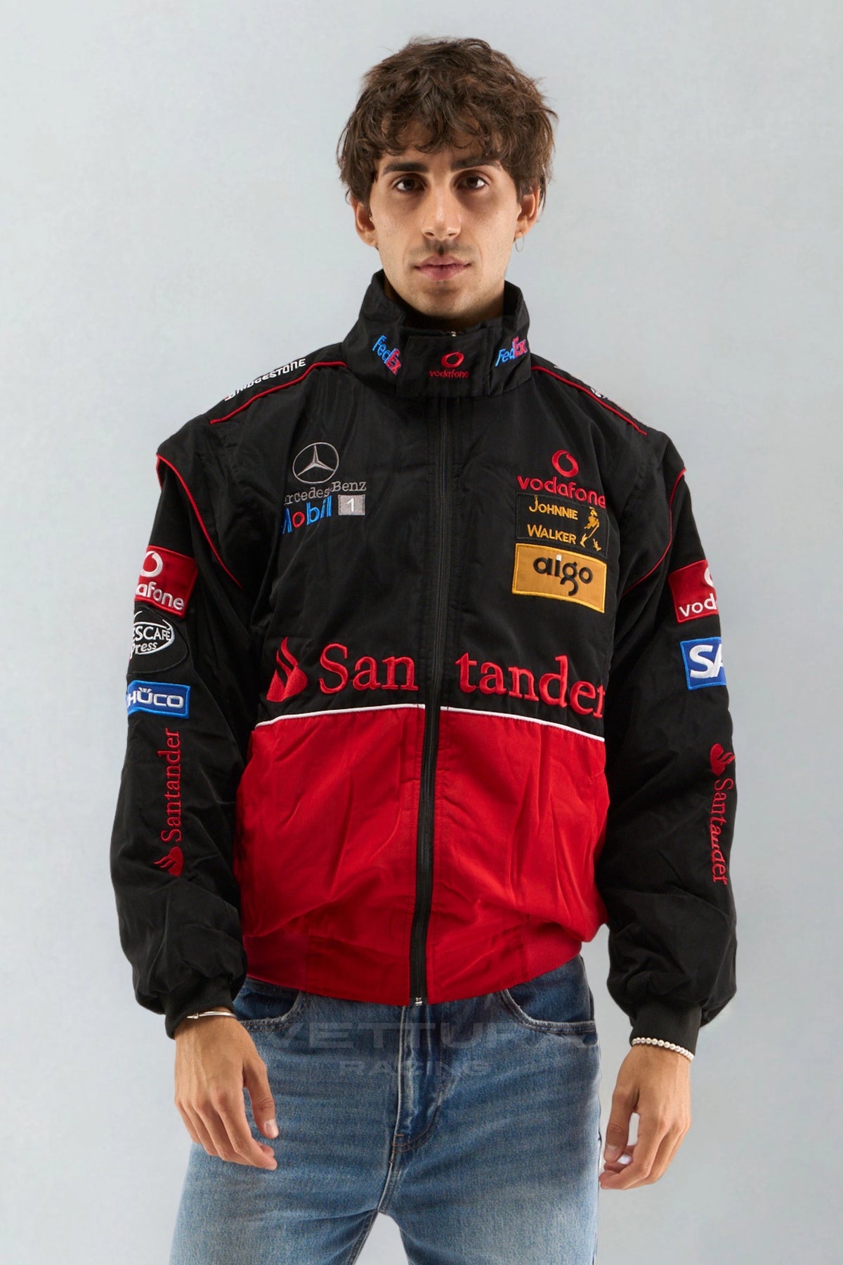 Model wearing the black and red McLaren Mercedes vintage F1 jacket, front view