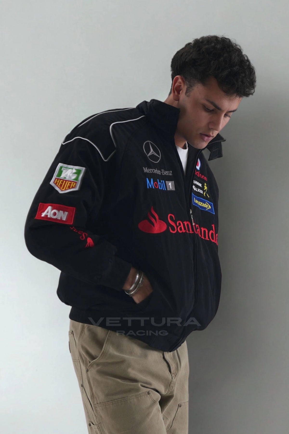 Side view of the black Mercedes-Benz Santander vintage F1 jacket on a model