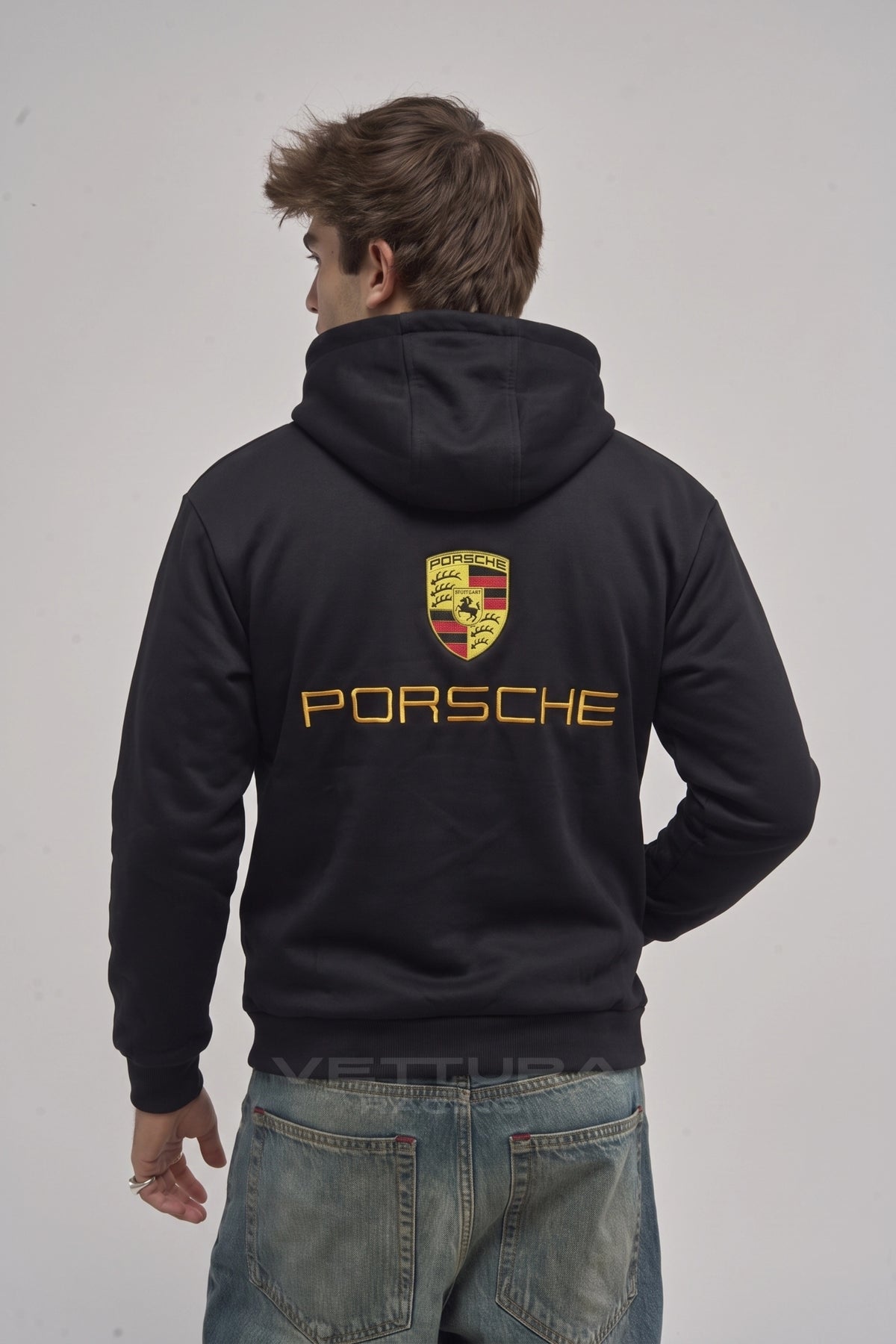 Model wearing the Porsche racing embroidered hoodie in black