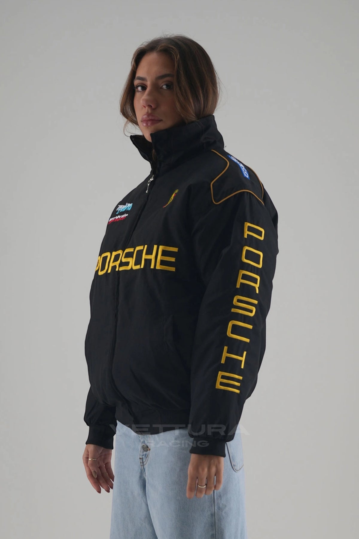 Woman wearing the black Porsche vintage racing bomber jacket