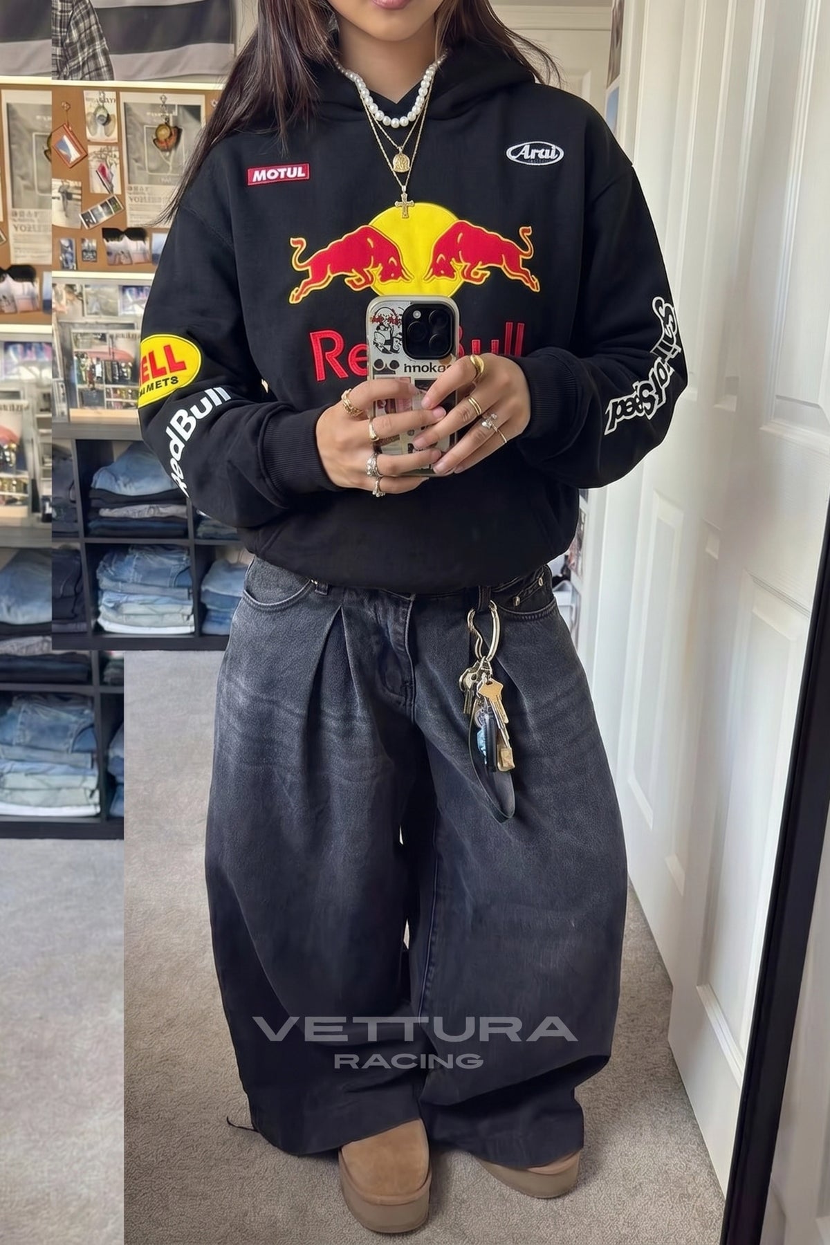 Close view of the embroidered Red Bull crest on the black hoodie