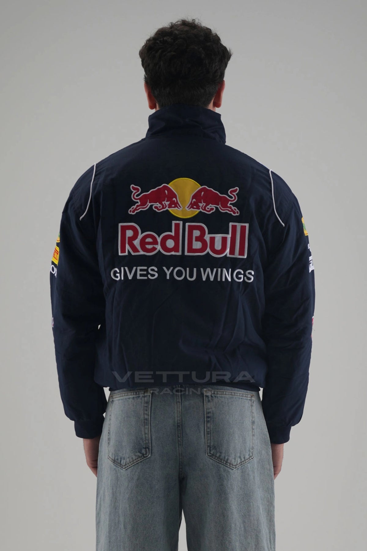 Back of the navy Red Bull F1 racing jacket on a model
