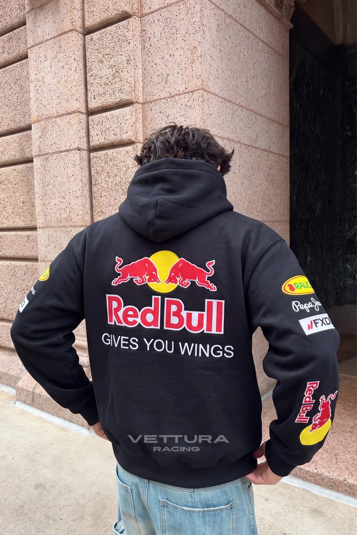 Back of the Red Bull Racing F1 hoodie worn outdoors, everyday styling