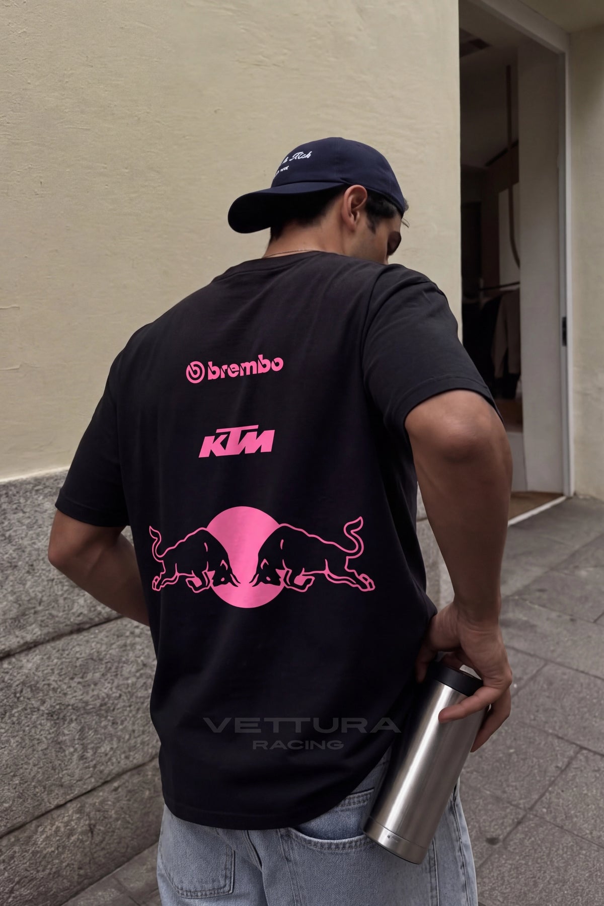 Model wearing the Red Bull racing t-shirt pink edition, regular fit