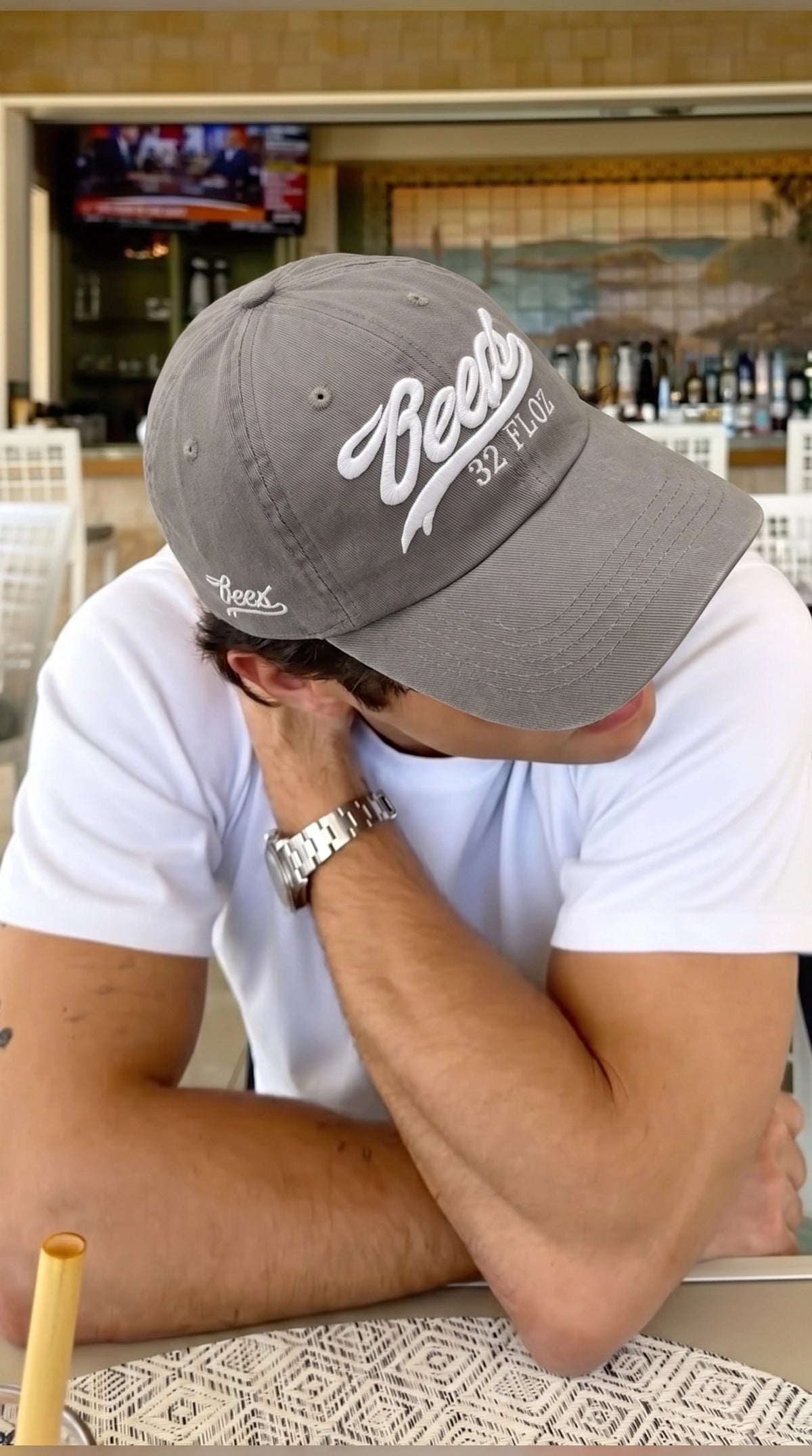 Model wearing the Reese's embroidered cap with the brim pulled low