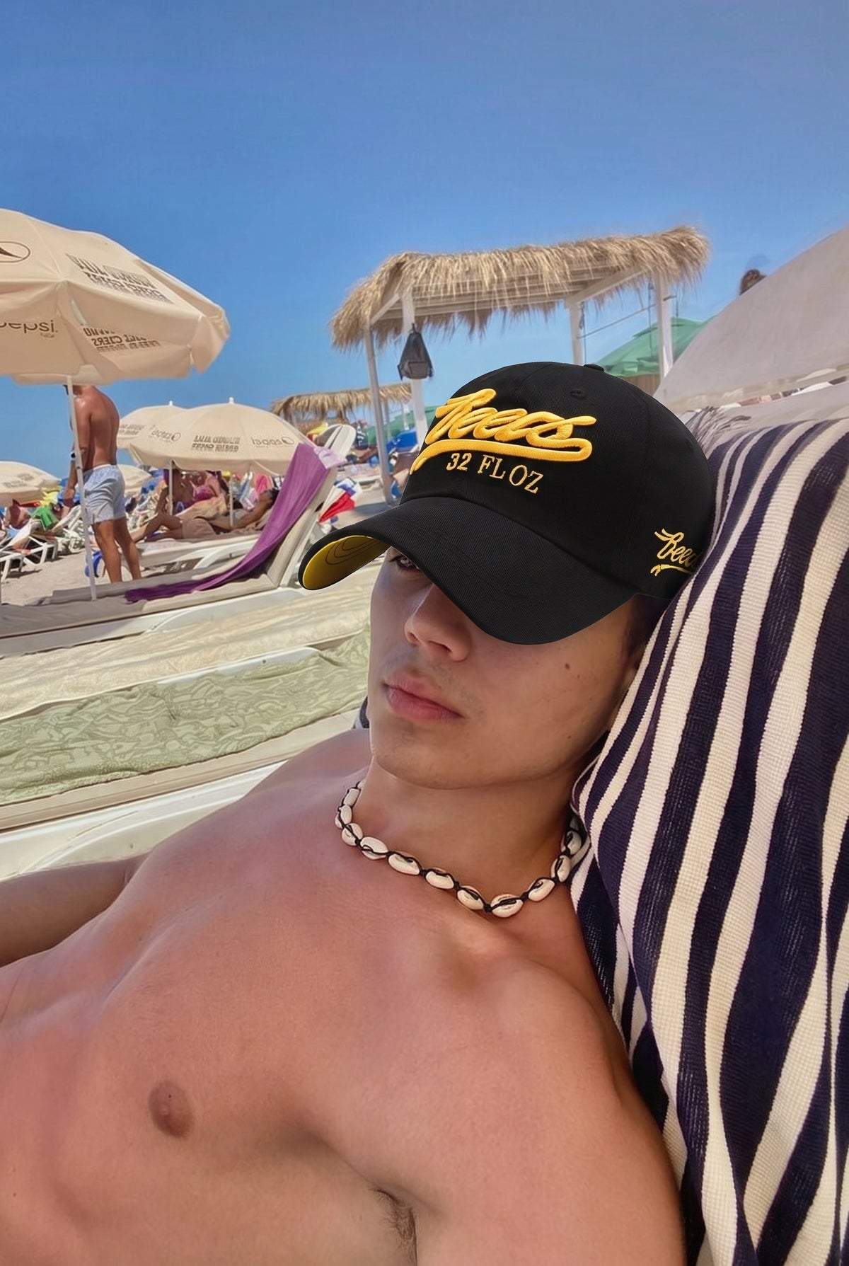 Black and yellow Reese's embroidered cap worn on the beach