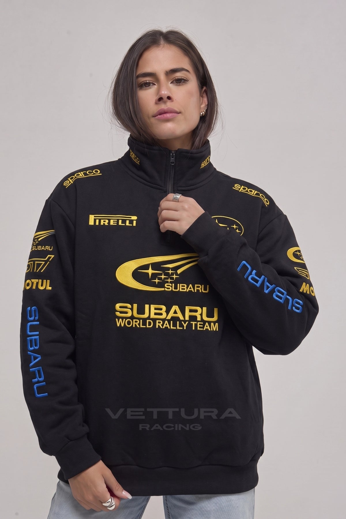 Model wearing the Subaru World Rally embroidered zip sweatshirt in black
