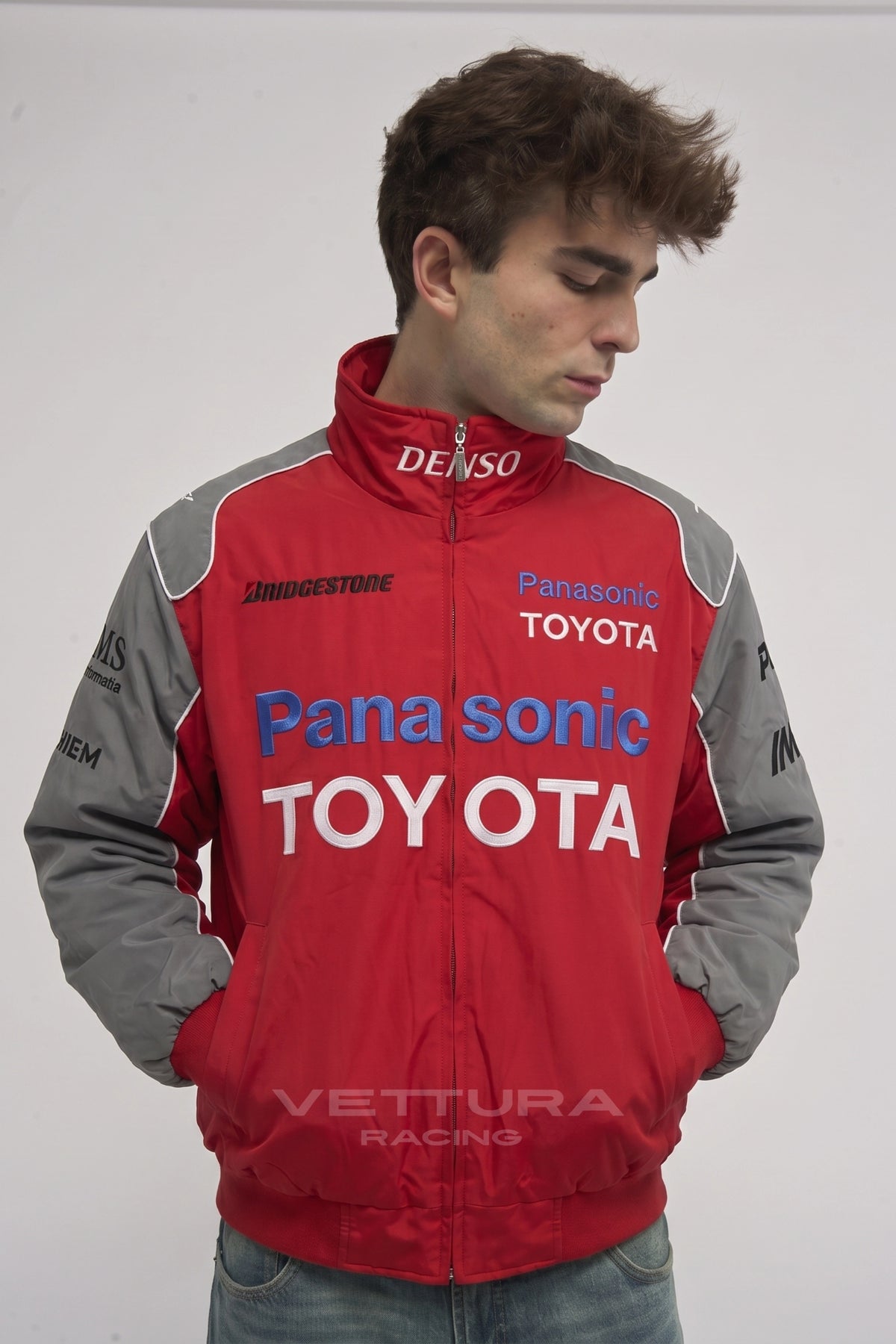 Close view of the Denso and Bridgestone patches on the Toyota jacket