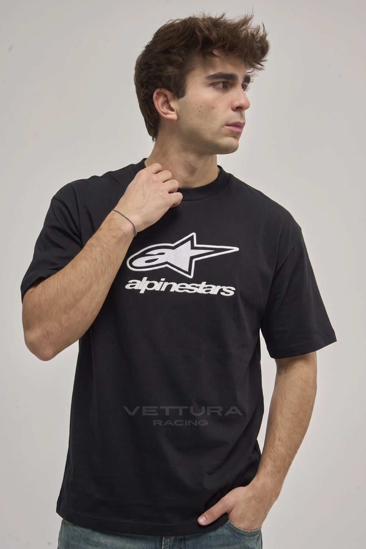 Man wearing the Alpinestars racing t-shirt in black, front view with the white star mark