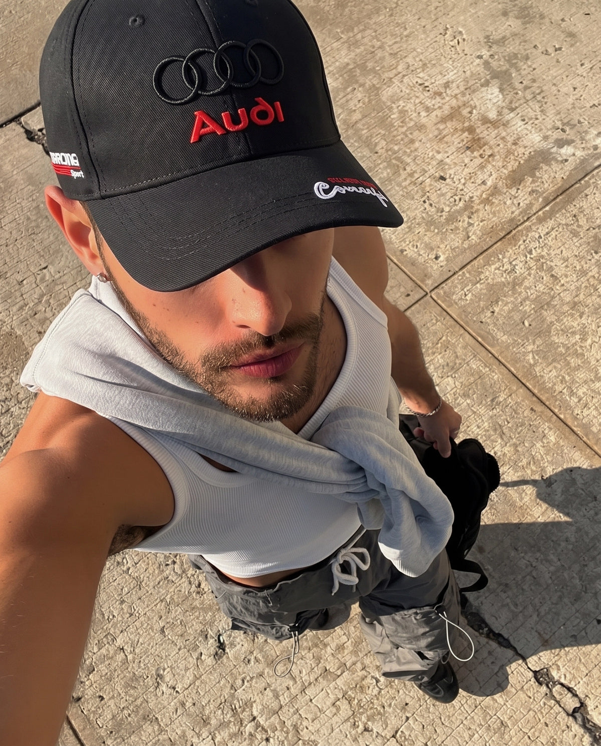 Model wearing the black Audi Racing embroidered cap