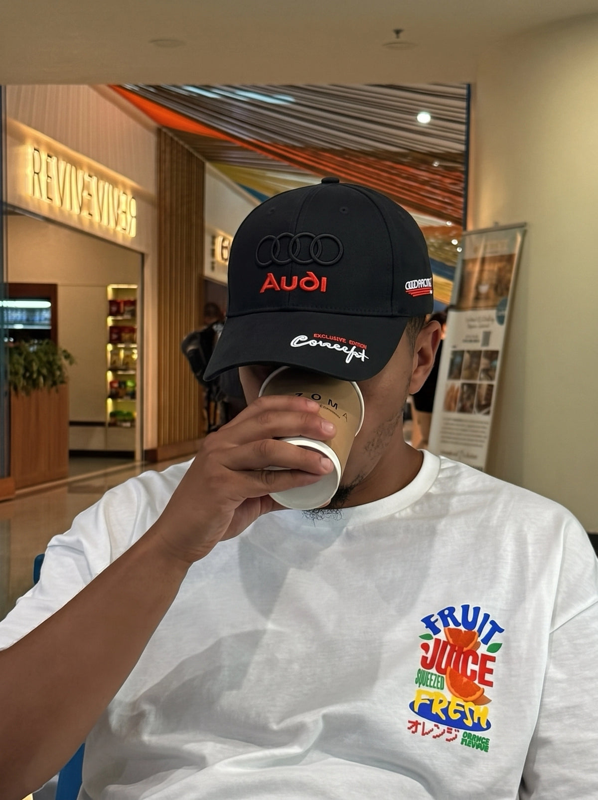 Audi Racing cap worn indoors with a white tee