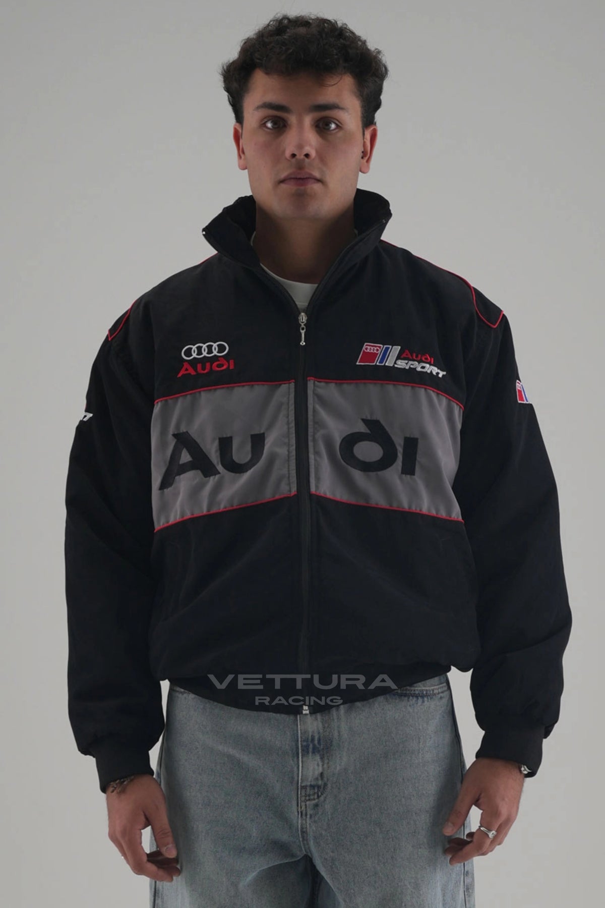 Model wearing the black Audi vintage racing jacket, front view