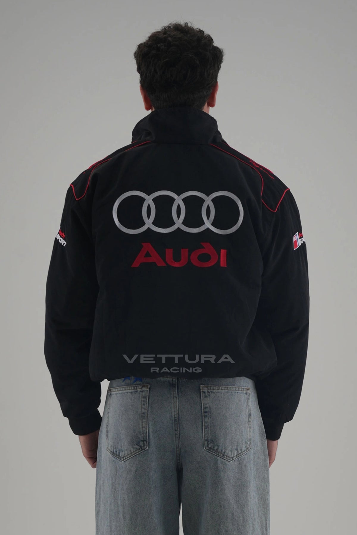 Back of the black Audi vintage racing jacket on a model