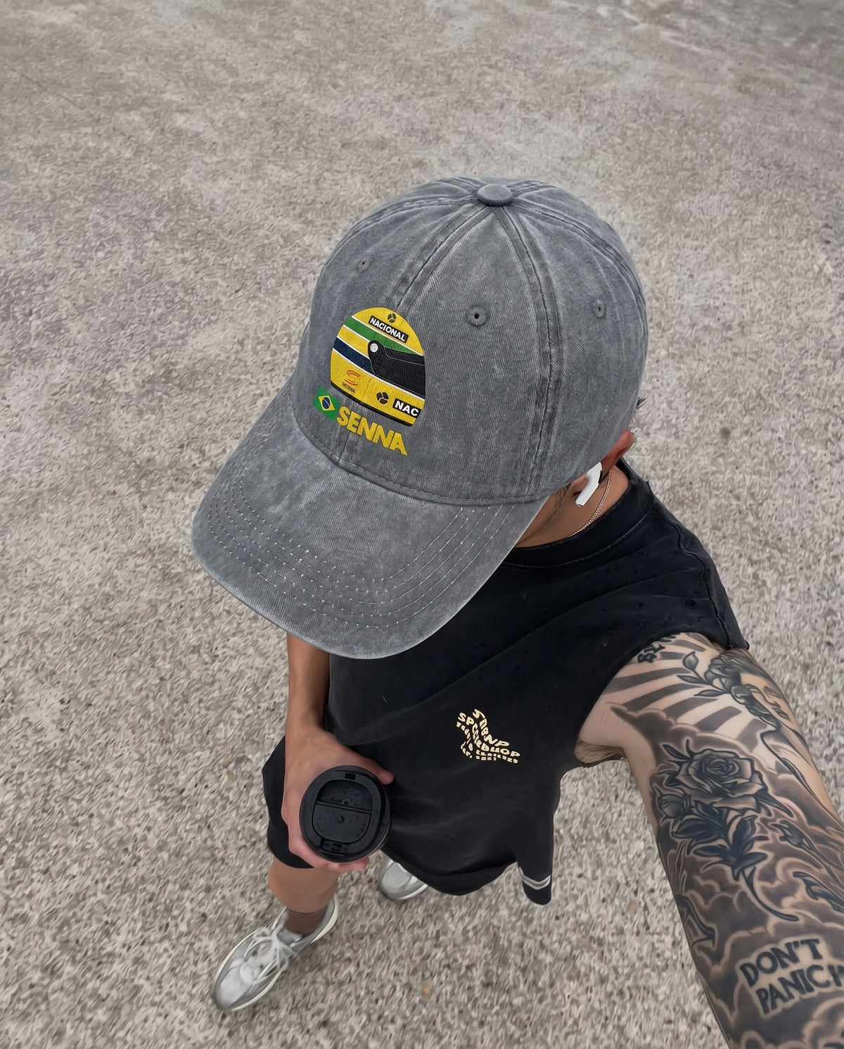 Gray Senna F1 cap worn low over the eyes