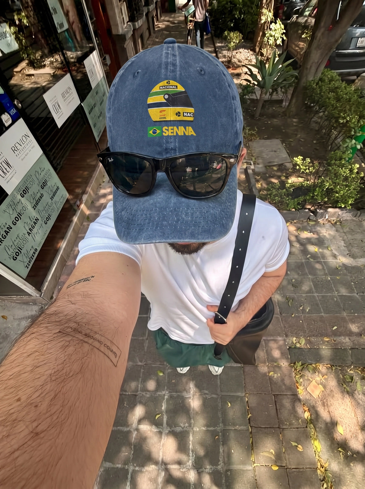 Navy Senna F1 cap worn with sunglasses