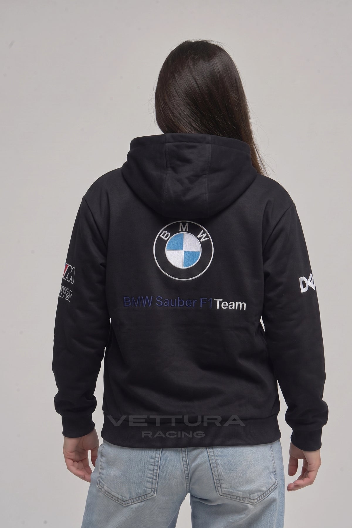 Model wearing the BMW F1 racing embroidered hoodie in black