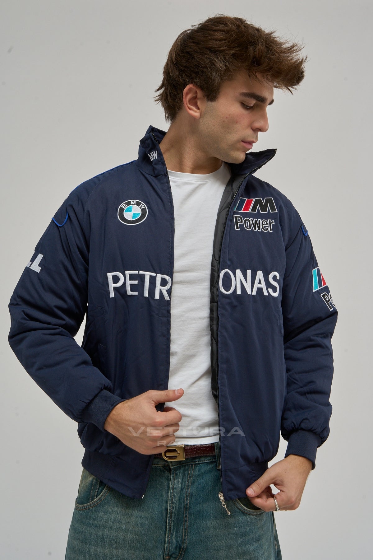 Model wearing the navy BMW Petronas vintage F1 racing jacket, front view