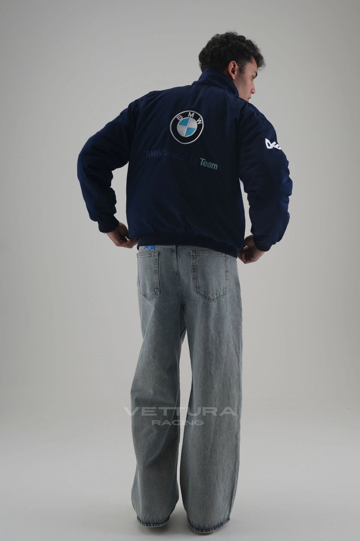 Back of the navy BMW M Power vintage racing jacket on a model