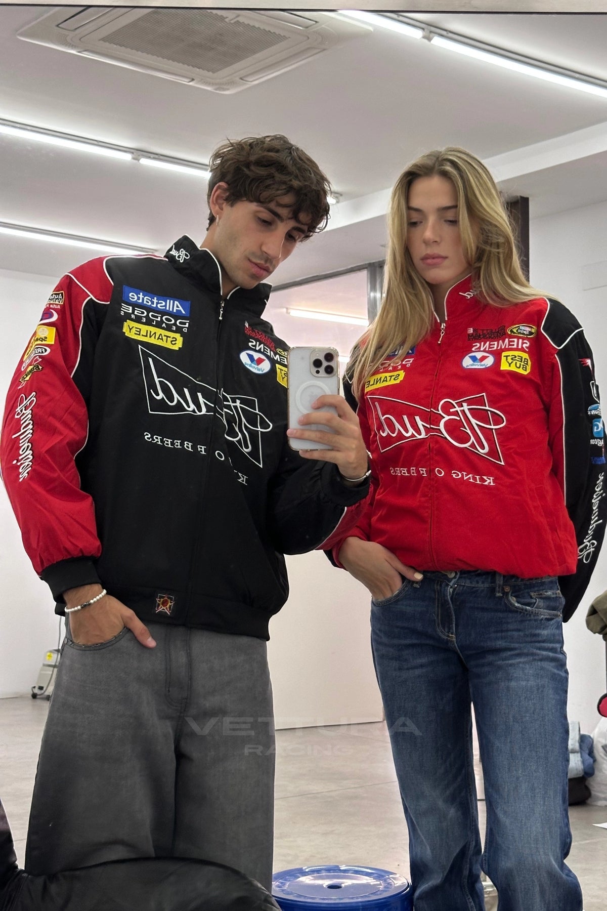 Two people wearing Budweiser NASCAR vintage racing jackets