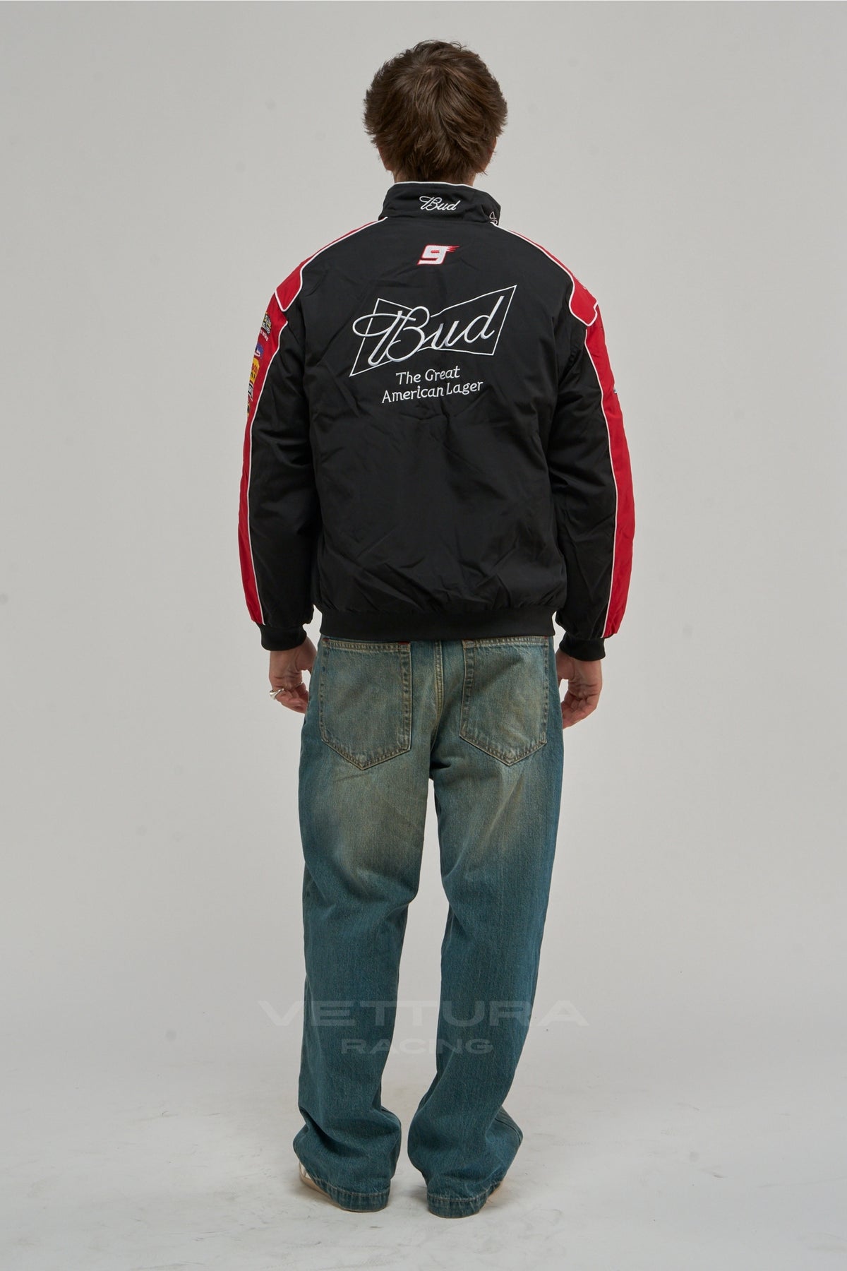 Back of the black Budweiser NASCAR vintage racing jacket on a model