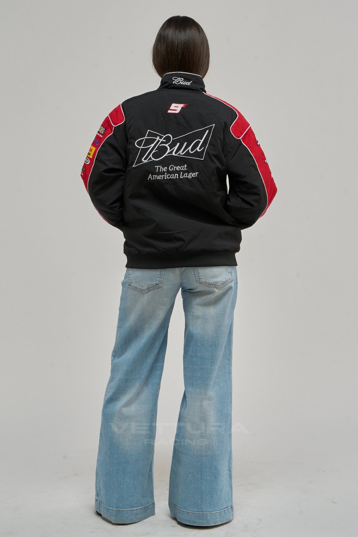 Rear view of the Budweiser NASCAR bomber worn with wide leg jeans