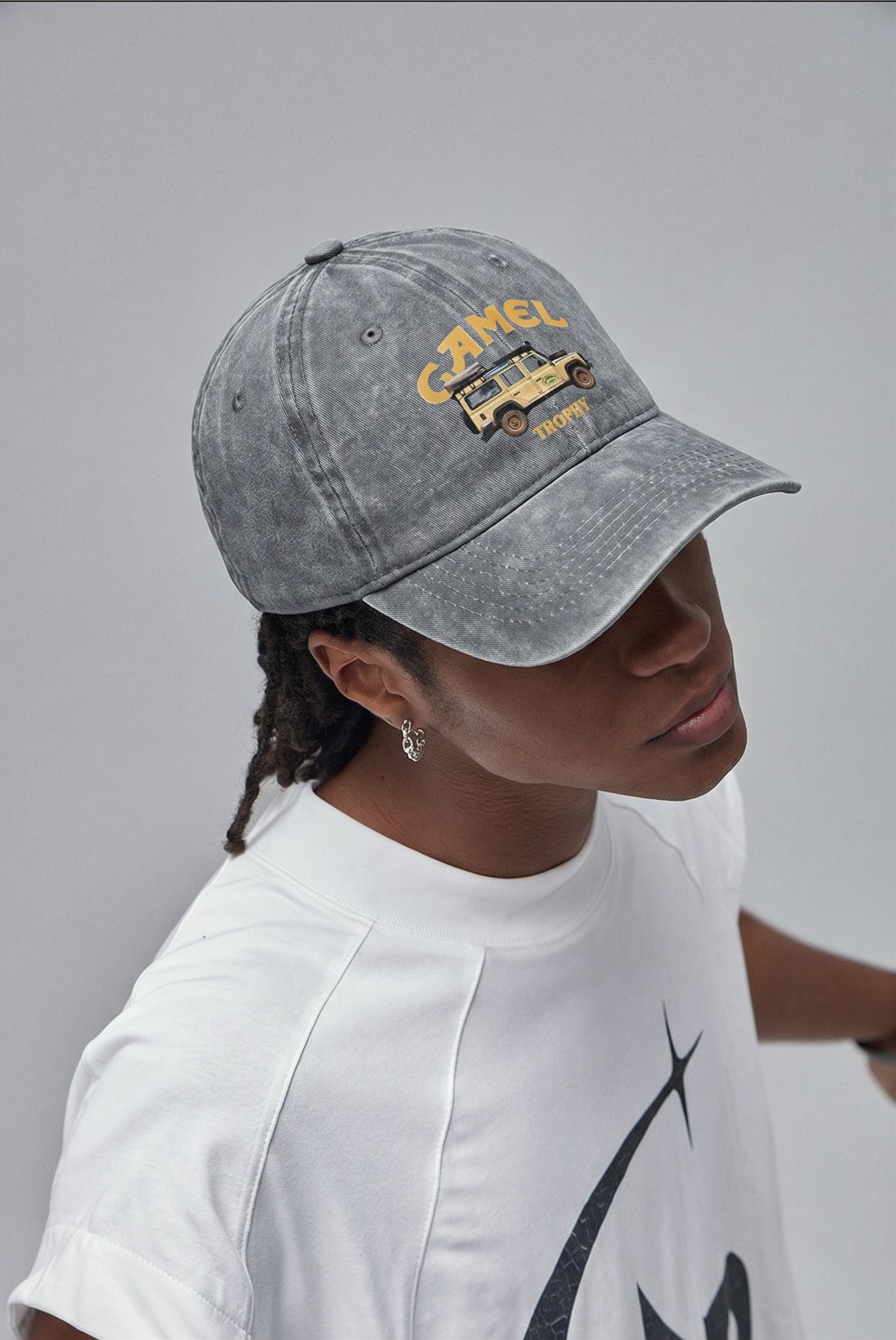 Gray Camel 4x4 cap worn with a white tee