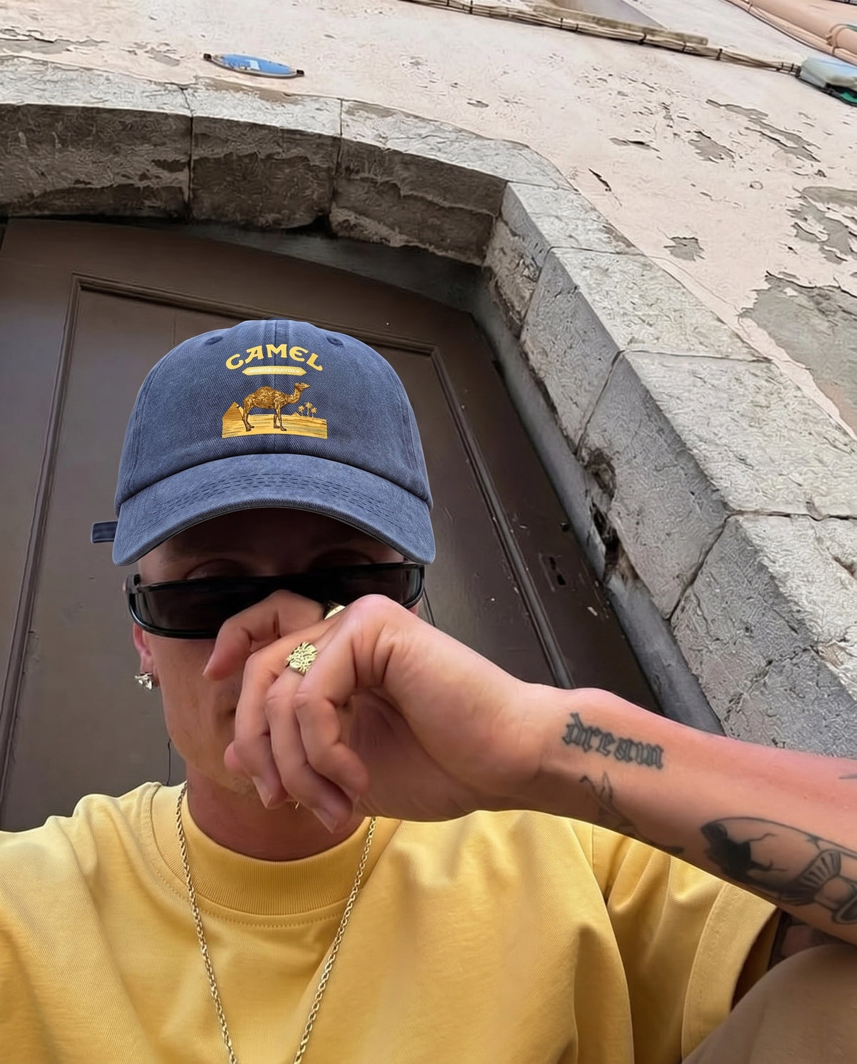 Navy Camel Desert cap worn with a yellow tee