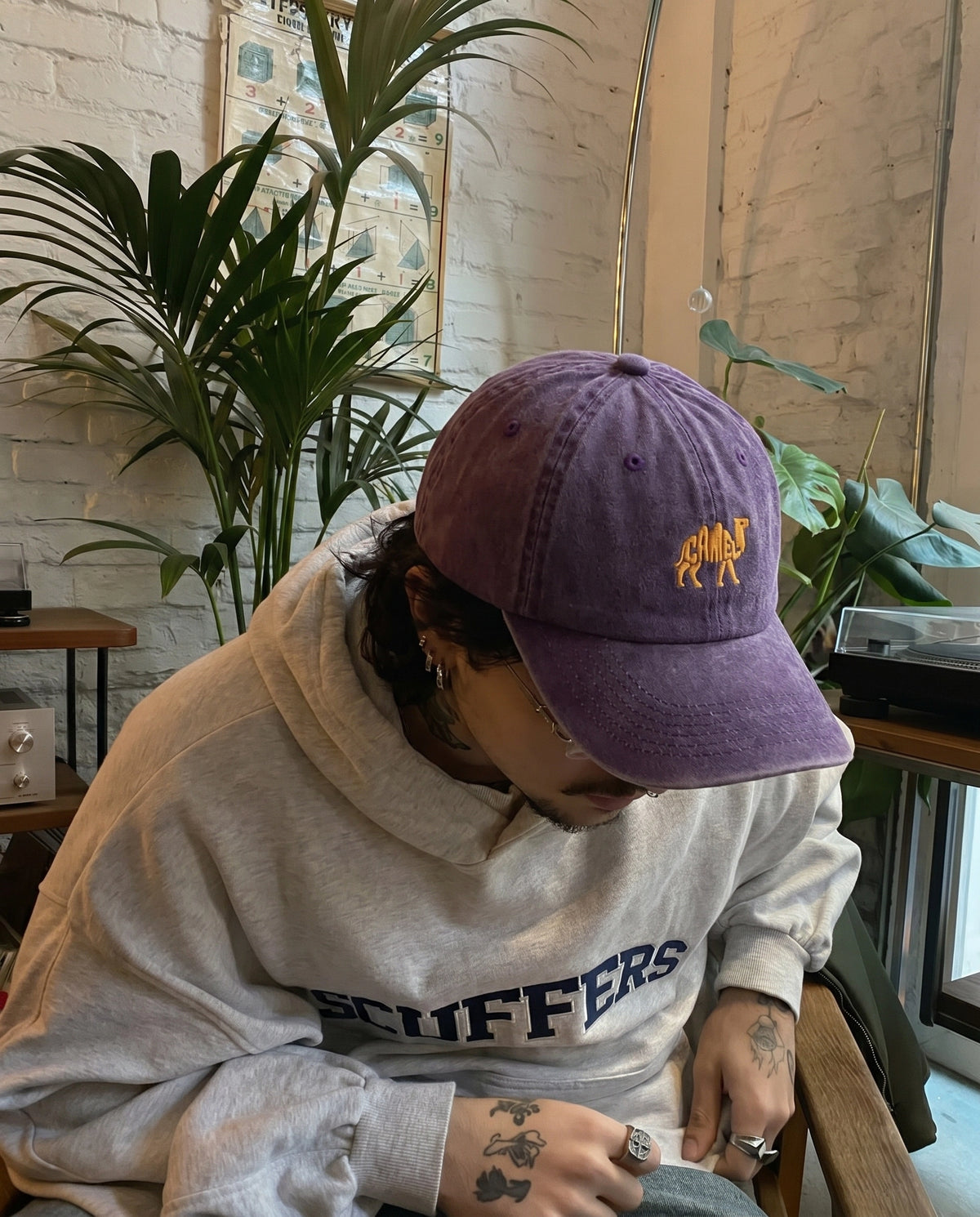 Model wearing the plum purple Camel embroidered cap
