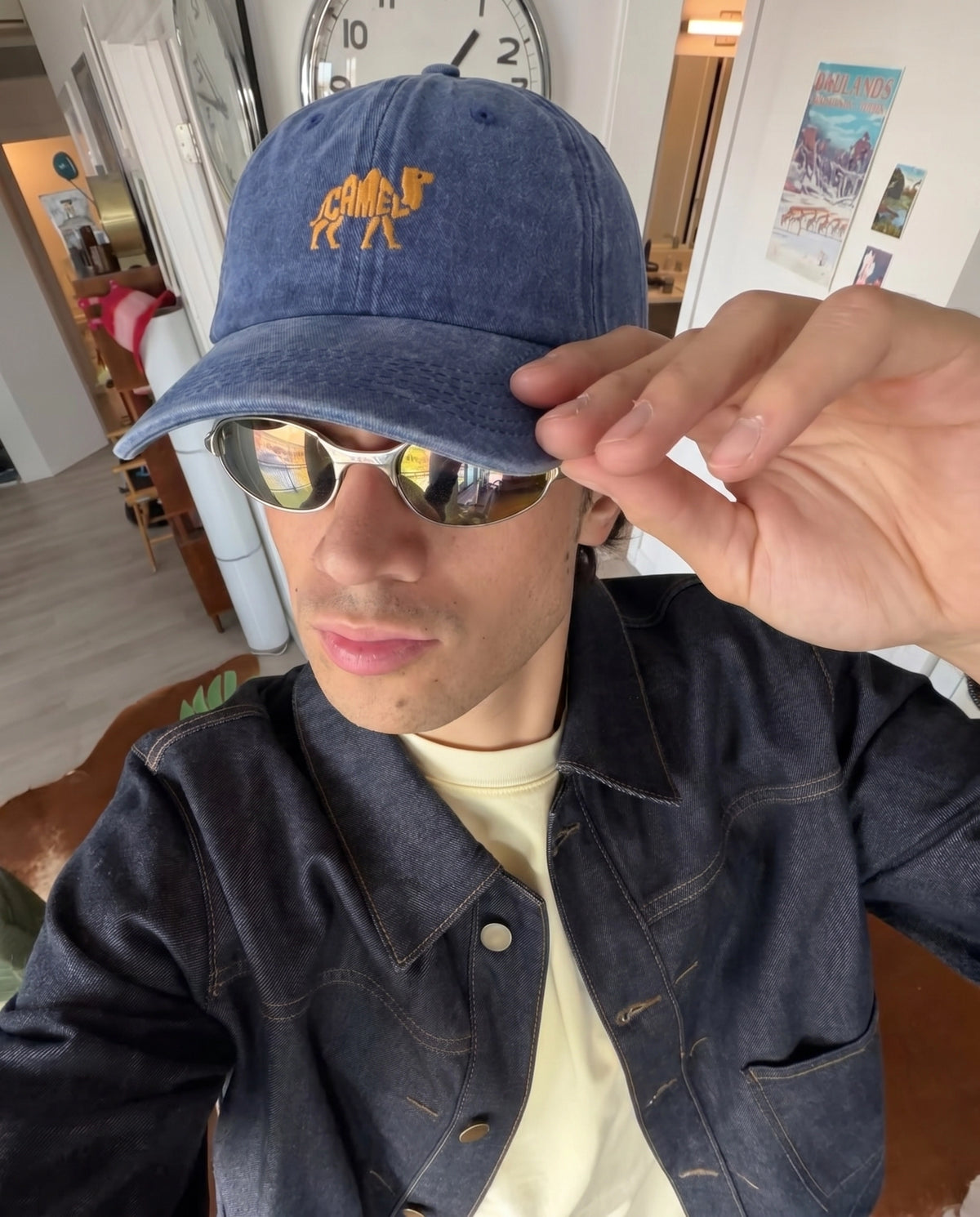 Camel embroidered cap worn with sunglasses