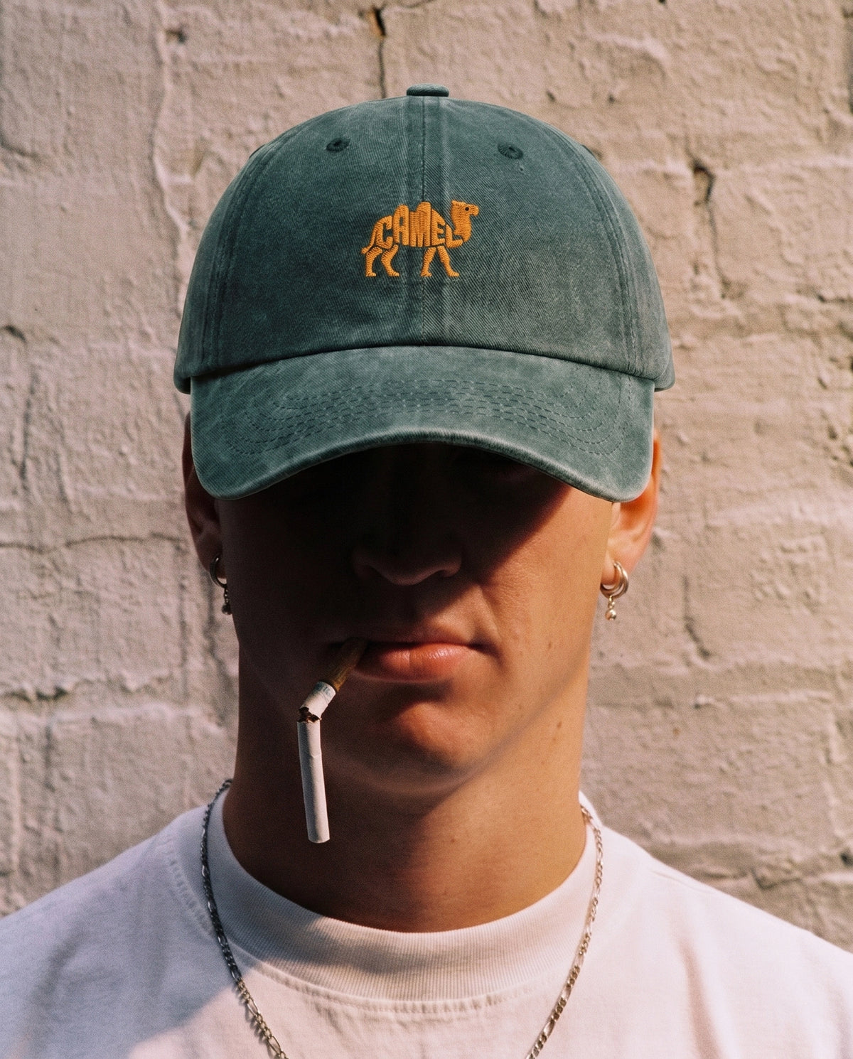 Green Camel embroidered cap worn on the street