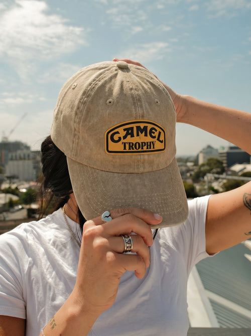 Model wearing the beige Camel Trophy cap outdoors